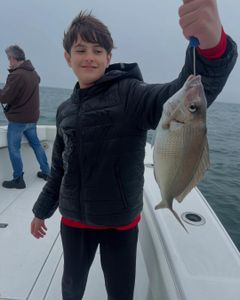 A Scup fish caught by two people fishing in Yarmouth