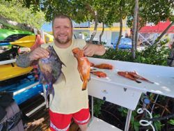 Two small fish caught in Cabo Rojo with fishing and water sports equipment