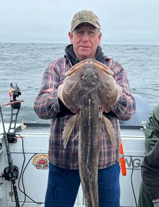 Angler with big 24-inch fish on fishing tour in Roseburg