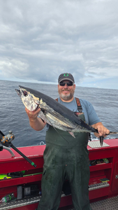 Reeling in a huge Blackfin Tuna on a picture-perfect day!