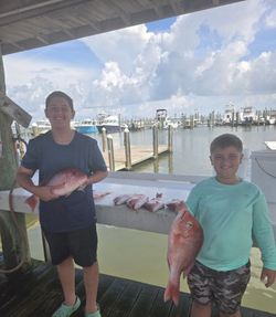 Two people fishing at Fort Morgan