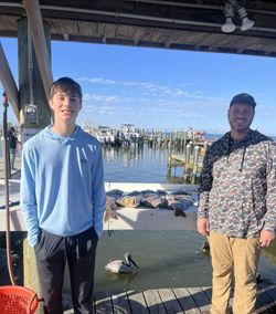 Two people fishing at Fort Morgan