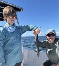 Two people fishing at Fort Morgan