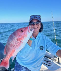 A person enjoying fishing at Fort Morgan