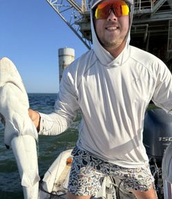 Fishing charter boat with catch near Fort Morgan AL offshore platform