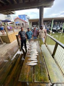 Group of four people fishing in Galveston
