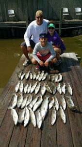 Three people fishing at Galveston