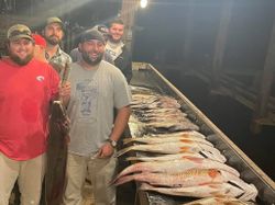 4 people fishing in Grand Isle