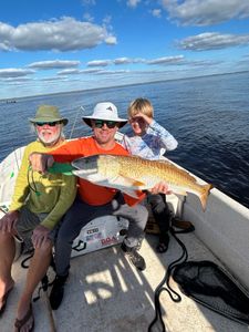 3 anglers fishing in Florida with a 28-inch fish