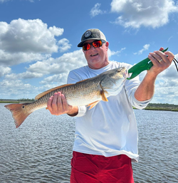 A lone fisherman reeling in a big catch in Florida