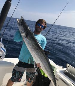 A person fishing for a king mackerel in Panama City