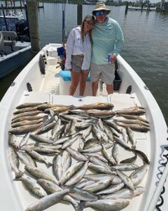 Angler holding a spotted weakfish in LA
