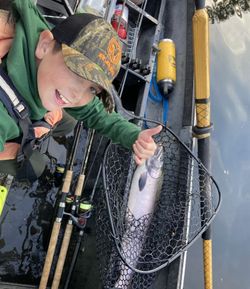 Happy young angler with a fresh steelhead catch!