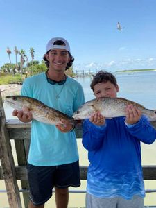 Two fishermen with their catch in TX