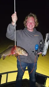A person fishing in Elk Rapids
