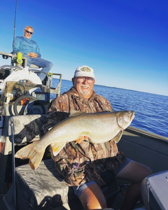 Two people fishing in Elk Rapids