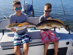 Two anglers proudly displaying their catch in Florida