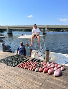 Three people enjoying a day of fishing on Pensacola Beach