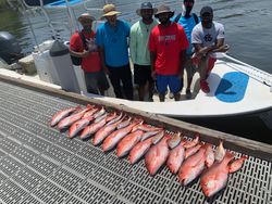 A group of 7 people fishing at Pensacola Beach
