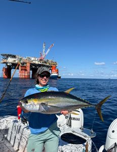A person fishing for a yellowfin tuna in Venice, Italy