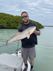 Single angler holding a 21-inch fishing catch in FL