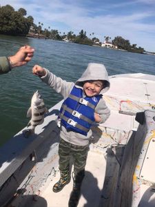 A person fishing for a black drum fish in Florida