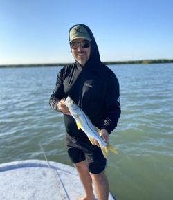 A fisherman with a snook fish at South Padre Island