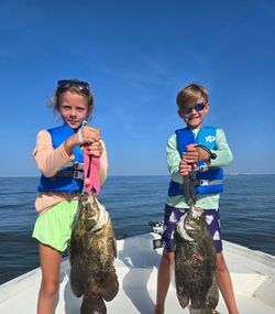 Two tripletail fish caught by two people in MS