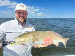 A person fishing in the waters of Port Isabel