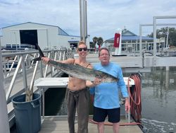 Two people fishing with a single catch in FL