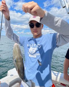 An angler holds a freshly caught fish in Middletown Township