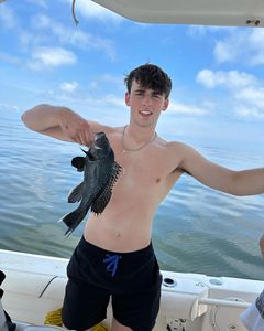 Fisherman holding a sea bass in Middletown Township