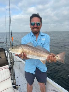 Proud angler with a solid redfish catch.