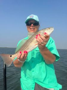 Confident angler with a bright redfish catch.