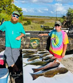 Two anglers reeling in a great catch of fish in Florida