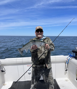 Angler with a 16-inch rainbow trout caught in NY