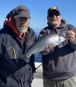 Angler holding a rainbow trout in Oswego