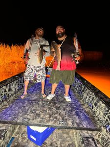 Two fishermen with their catch in Lafitte