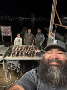 Successful alligator gar fishing trip displaying multiple large fish on cleaning station at Lafitte LA marina