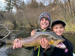 Angler holding a large sea trout caught while fishing in MI