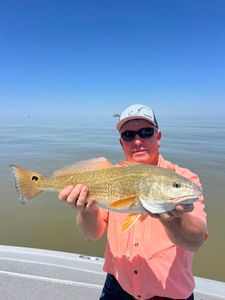 Smiles all around after a solid redfish trip