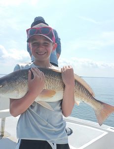 Redfish reeled in by kid in FL!