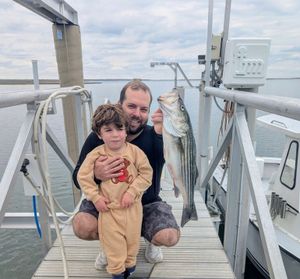 Father and son land first striped bass of the season