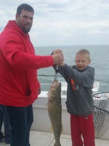 kid reels in Walleye in Lake Erie Fishing Charters