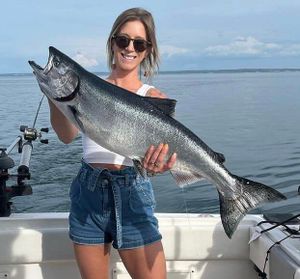 Flexing her trophy! Salmon Fishing on Lake Ontario