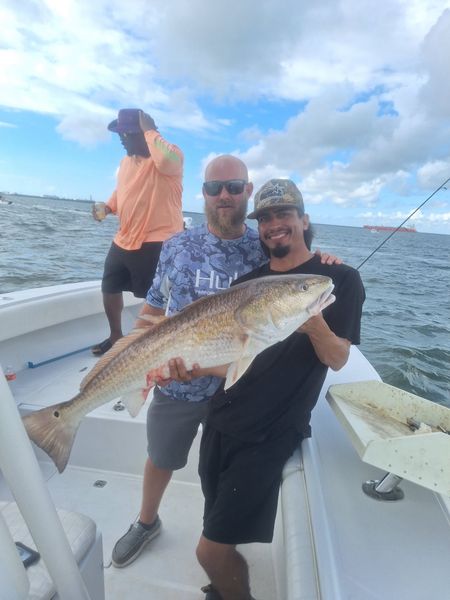 A proud angler celebrating a great catch during a Galveston TX fishing trip.