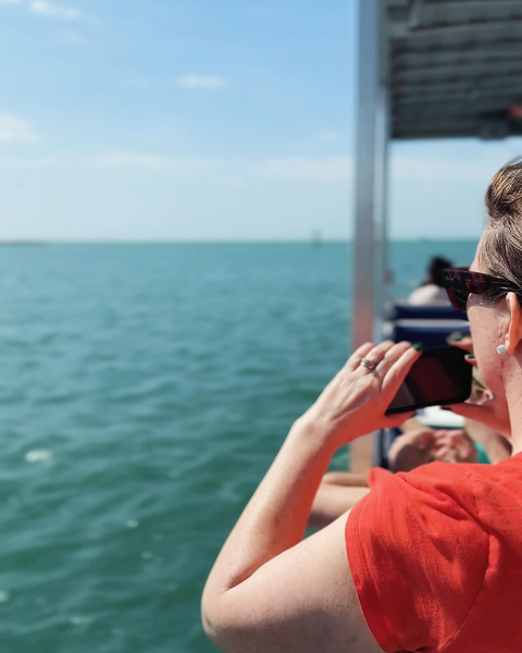 Guests relaxing on Flippers Fun Boat during a Clearwater Beach dolphin adventure.