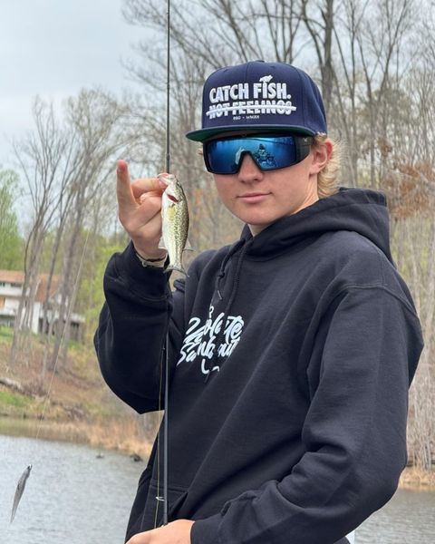 Small largemouth bass catch on freshwater fishing trip