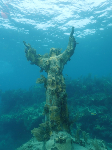 Coral-encrusted statue rests on Key Largo's ocean floor.