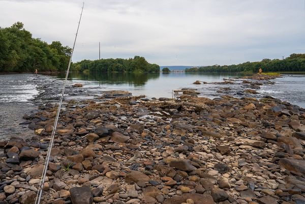 Perfect rocky shoreline setup for river fishing action.